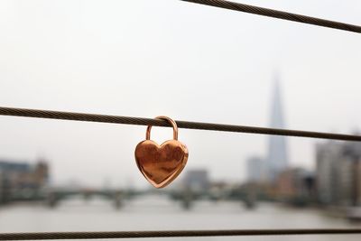 Close-up of padlocks on railing against river