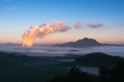 Sea of fog in the mountains, high voltage pole and steam from coal power plant. mae moh, lampang, 