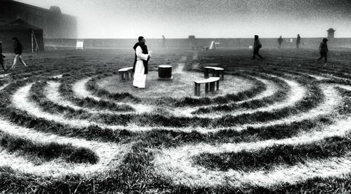 Priest praying on labyrinth field