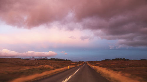 Empty road along countryside landscape