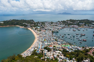 High angle view of sea and city against sky