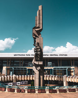 Low angle view of statue against building against sky