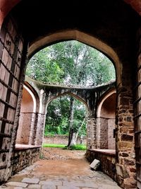 Archway against trees seen through arch