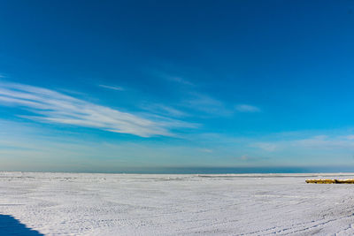 Scenic view of beach against blue sky