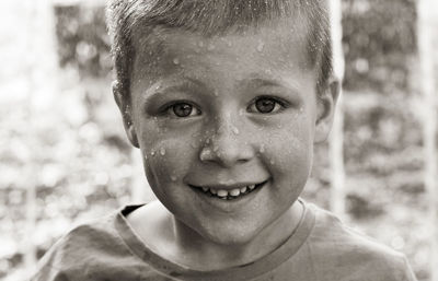 Close-up portrait of boy with wet face