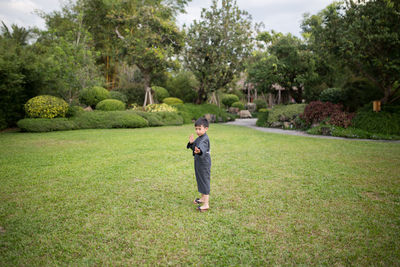 Full length of boy standing on field