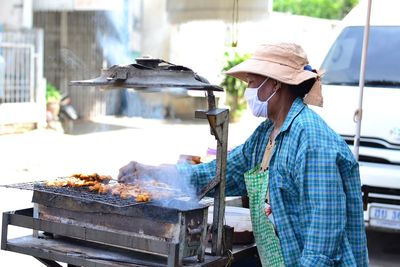 Man preparing food at market stall