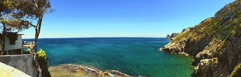 Scenic view of sea against clear blue sky