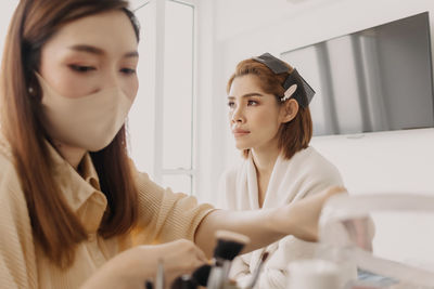 Portrait of smiling female friends working at home