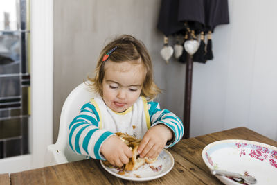 Girl eating food at home