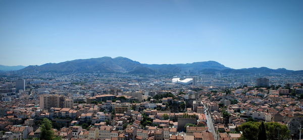 Cityscape against clear blue sky