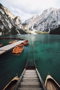 Scenic view of lake by snowcapped mountains against sky