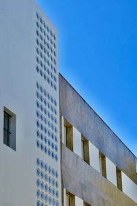Low angle view of building against clear blue sky