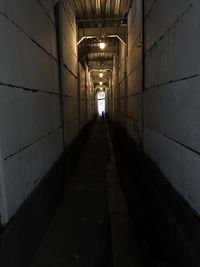 Empty corridor in illuminated building