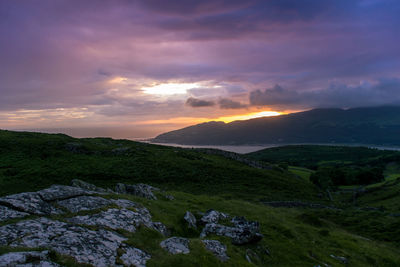 Scenic view of landscape against dramatic sky