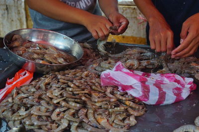 Midsection of people preparing food