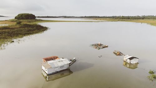 High angle view of boat floating on lake against sky