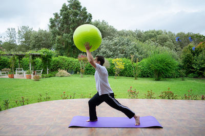 Full length of man playing with ball in park