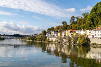 View at a house front in passau on the danube river in autumn with multicolored trees