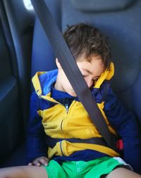 Rear view of boy sitting in airplane