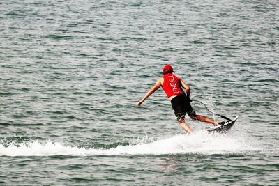 Woman jumping in sea