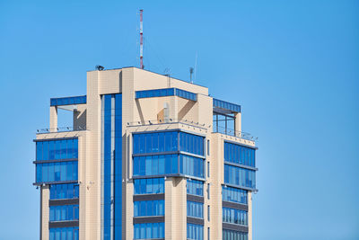 Low angle view of modern building against clear blue sky