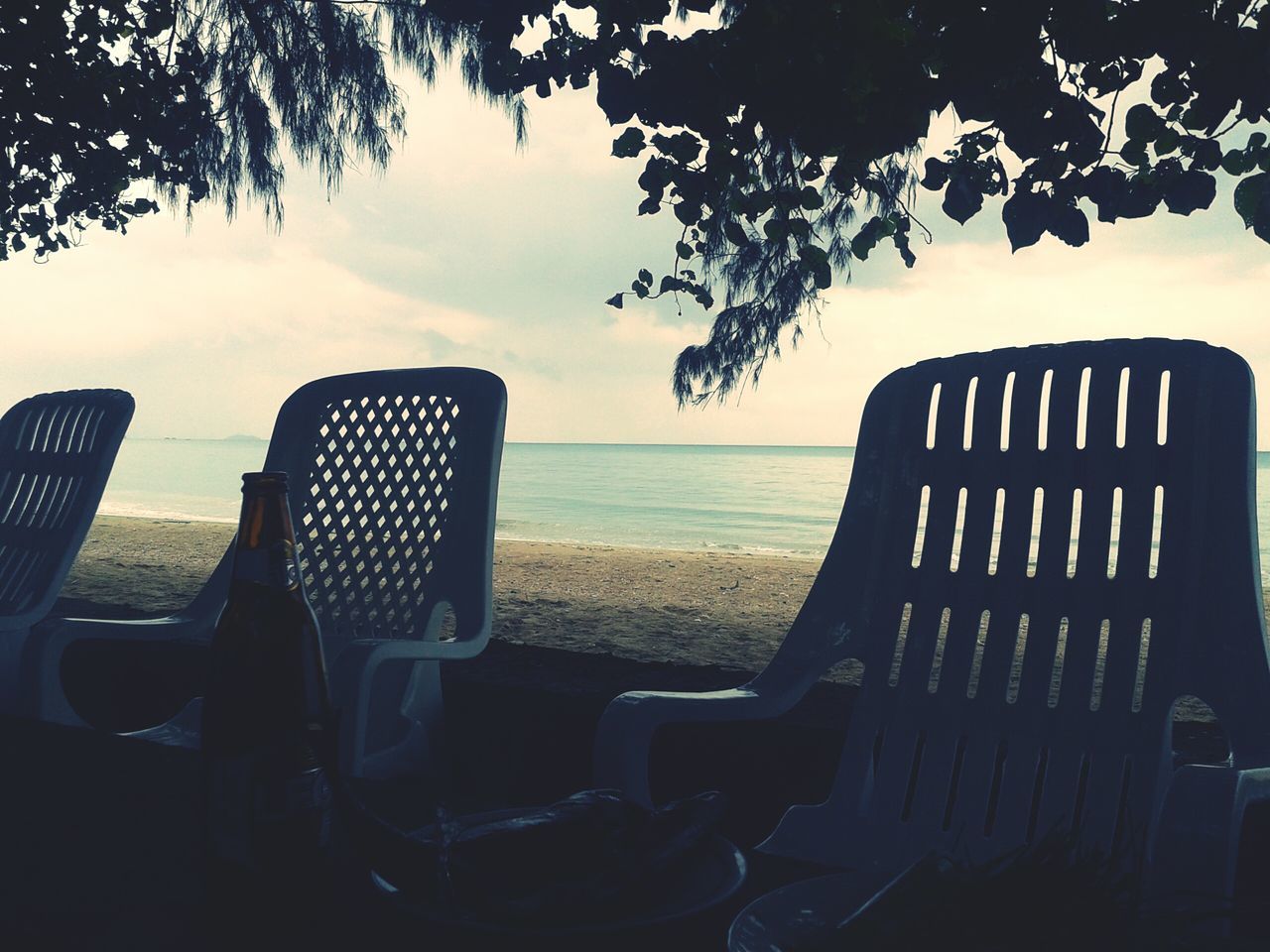 chair, sea, horizon over water, tranquility, water, absence, tranquil scene, sky, tree, empty, scenics, table, seat, beach, nature, bench, beauty in nature, sunlight, idyllic, relaxation