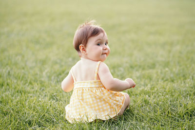 Cute girl looking away on field