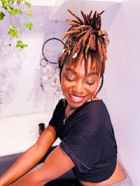 Portrait of young woman sitting on table