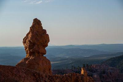 Rock formations on landscape against sky