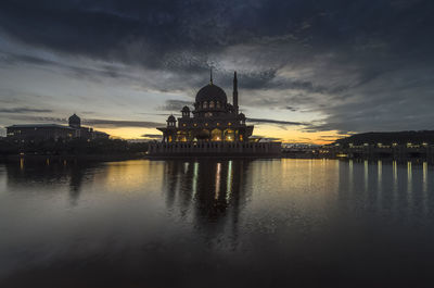 Reflection of built structures in water at sunset