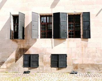 Low angle view of windows on wall of building