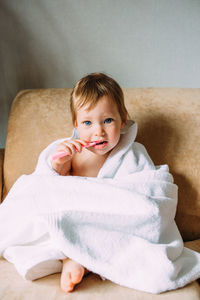 Portrait of cute girl sitting at home