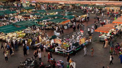 High angle view of people walking on street market