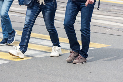 Low section of people standing on road