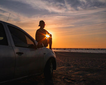 Side view of woman sitting on road