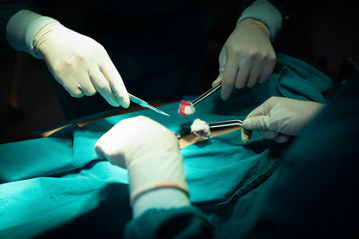 Midsection of doctor examining patient in hospital