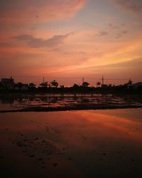 Agricultural field against sky during sunset