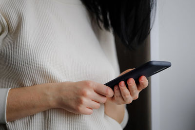 Woman holds a smartphone in her hands. touch screen smartphone, in hand. businesswoman 