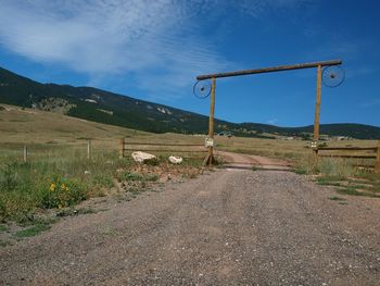 Road by landscape against sky