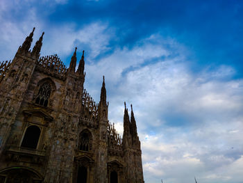 Low angle view of cathedral against cloudy sky