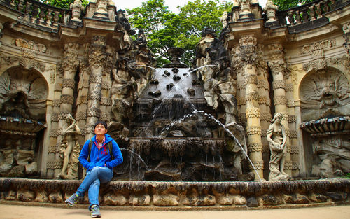 Portrait of smiling man statue outside building