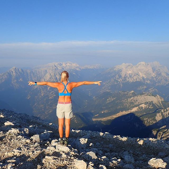 full length, lifestyles, leisure activity, standing, mountain, casual clothing, sky, tranquil scene, tranquility, scenics, rock - object, arms outstretched, beauty in nature, rear view, nature, mountain range, young adult, getting away from it all