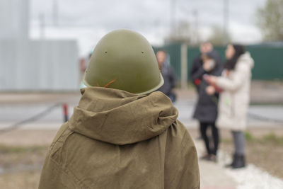 Rear view of people standing outdoors