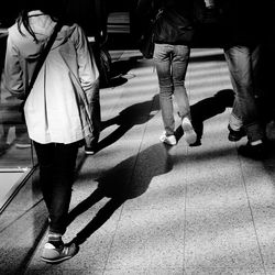 Low section of woman standing on tiled floor