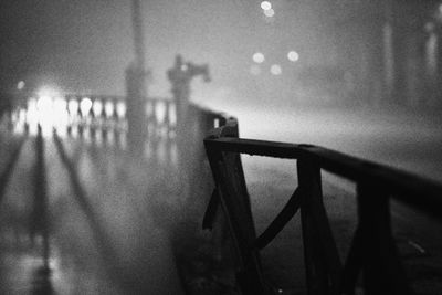 Shadow of person on wet railing