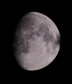 Low angle view of moon against clear sky at night