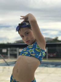 Cute girl wearing swimwear on poolside