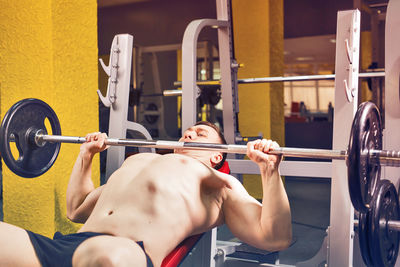 Midsection of man holding camera at home