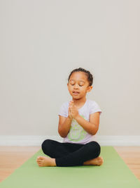 Full length of man sitting on floor